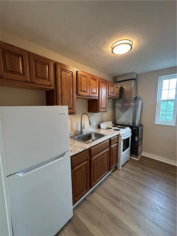 5900 Babcock Boulevard, Unit 35 Pittsburgh, PA 15237 - Photo 7 of 15 a kitchen with wooden cabinets and white appliances