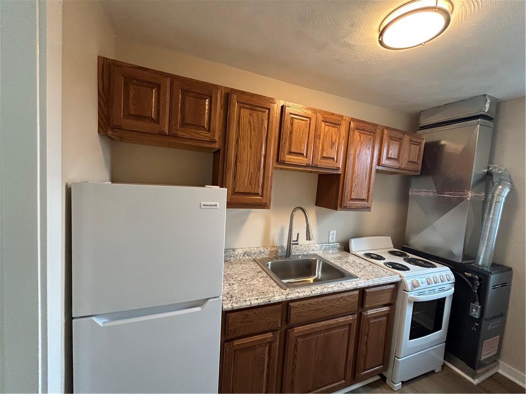 5900 Babcock Boulevard, Unit 35 Pittsburgh, PA 15237 - Photo 8 of 15 a kitchen with a sink a refrigerator and cabinets