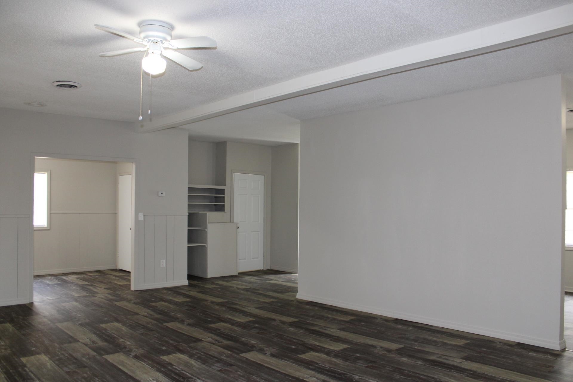 138 West Webb Avenue Ripley, TN 38063 - Photo 11 of 31 a view of a livingroom with a ceiling fan window and wooden floor