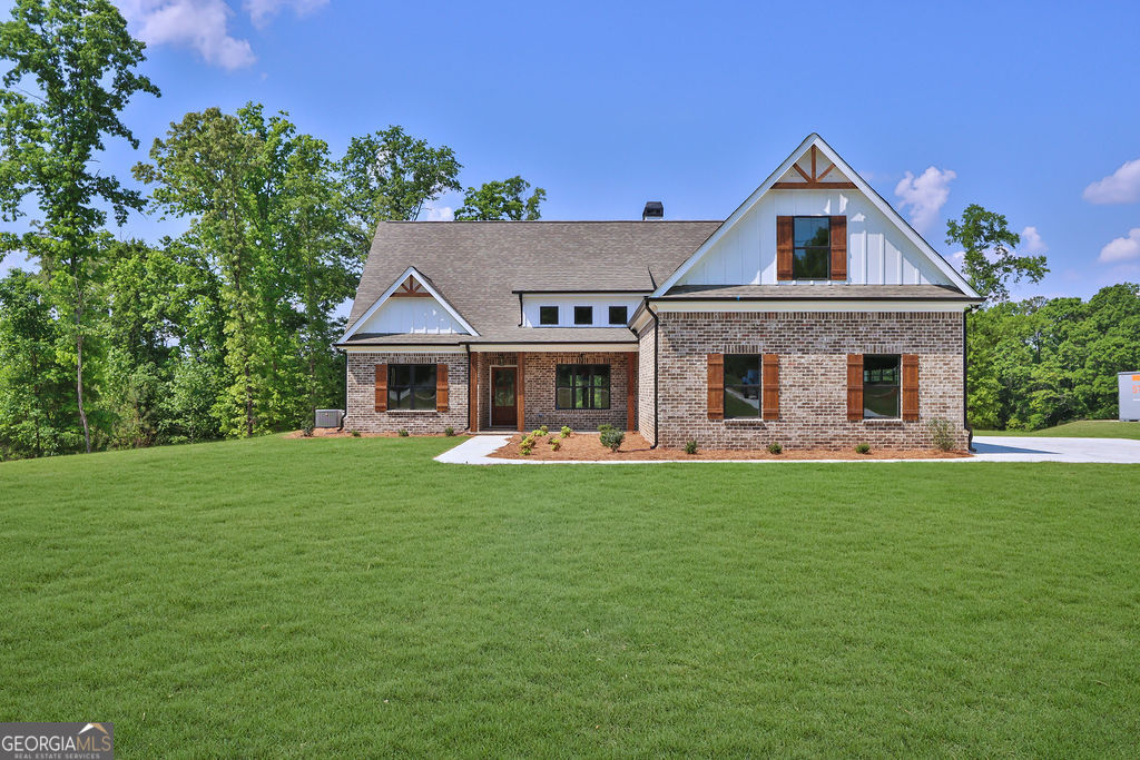 720 Youth Jersey Road Loganville, GA 30052 - Photo 1 of 31 a front view of a house with a garden