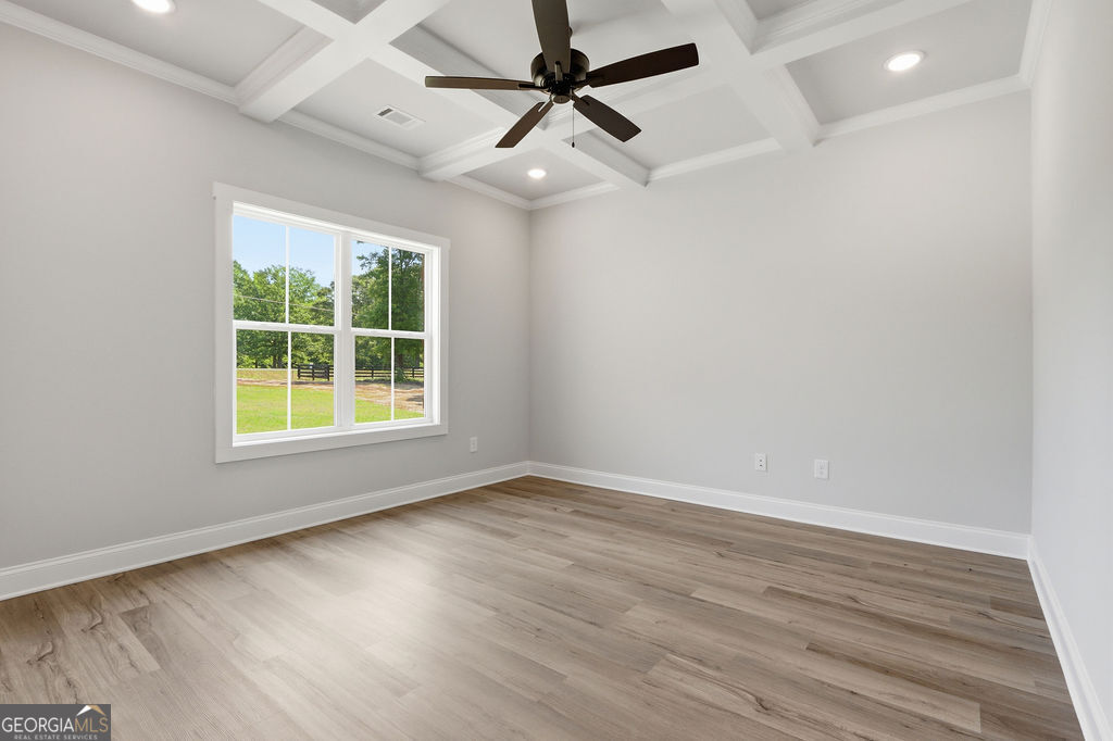 720 Youth Jersey Road Loganville, GA 30052 - Photo 13 of 31 an empty room with wooden floor and windows