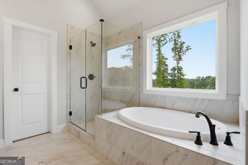 720 Youth Jersey Road Loganville, GA 30052 - Photo 18 of 31 a bathroom with a tub and a shower