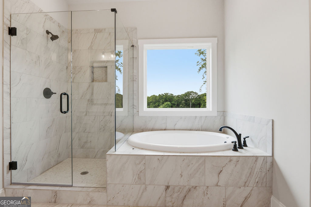 720 Youth Jersey Road Loganville, GA 30052 - Photo 19 of 31 a bathroom with a tub and a shower