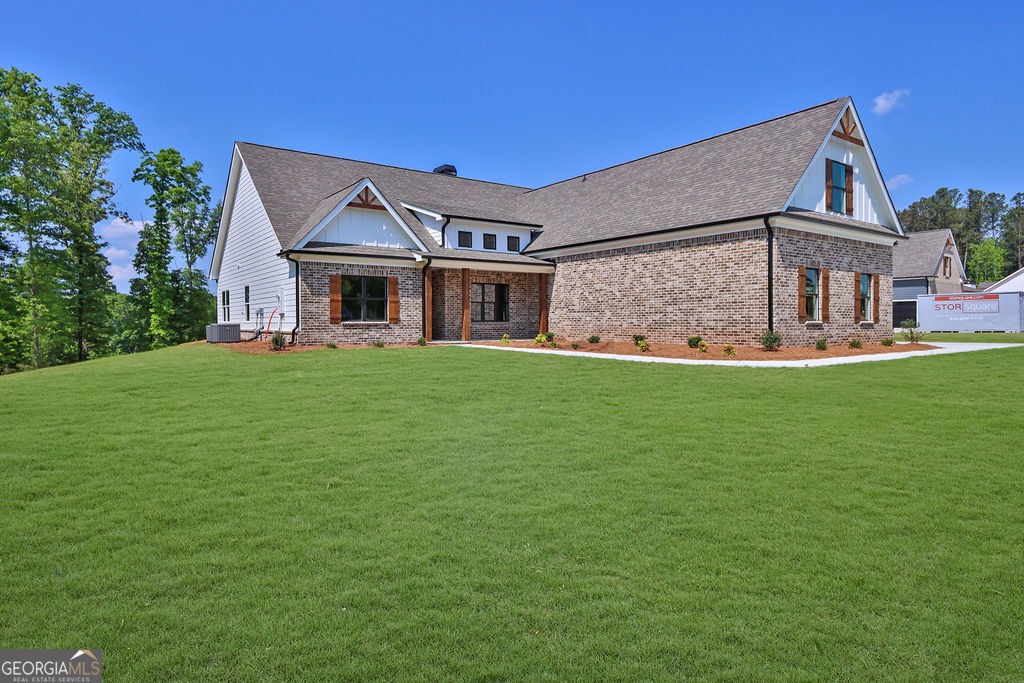 720 Youth Jersey Road Loganville, GA 30052 - Photo 2 of 31 a front view of a house with a yard and garage