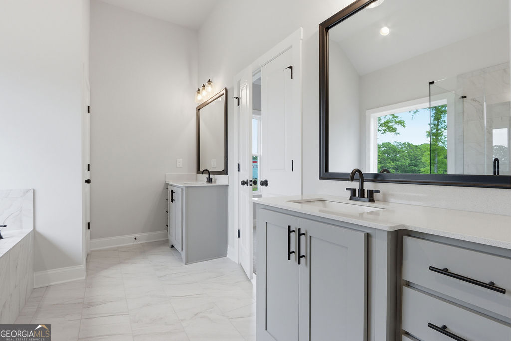 720 Youth Jersey Road Loganville, GA 30052 - Photo 21 of 31 a bathroom with a sink and a mirror