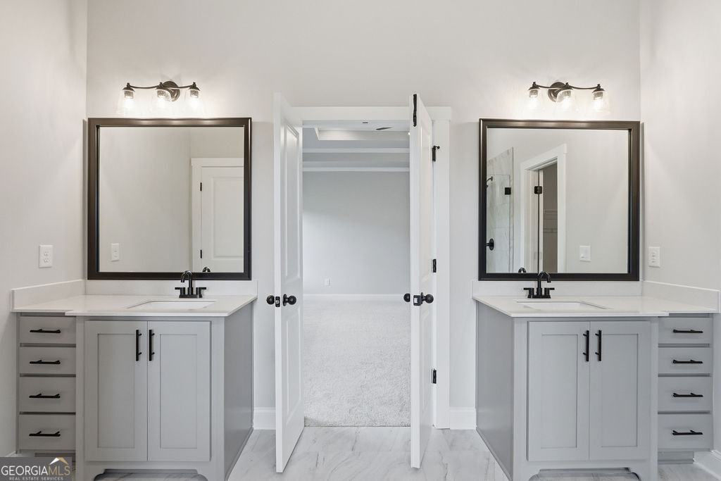 720 Youth Jersey Road Loganville, GA 30052 - Photo 22 of 31 a bathroom with a granite countertop sink and a mirror