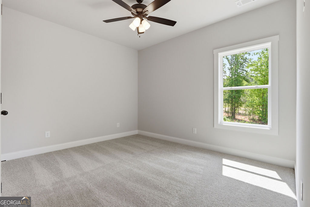 720 Youth Jersey Road Loganville, GA 30052 - Photo 24 of 31 an empty room with a window and a fan
