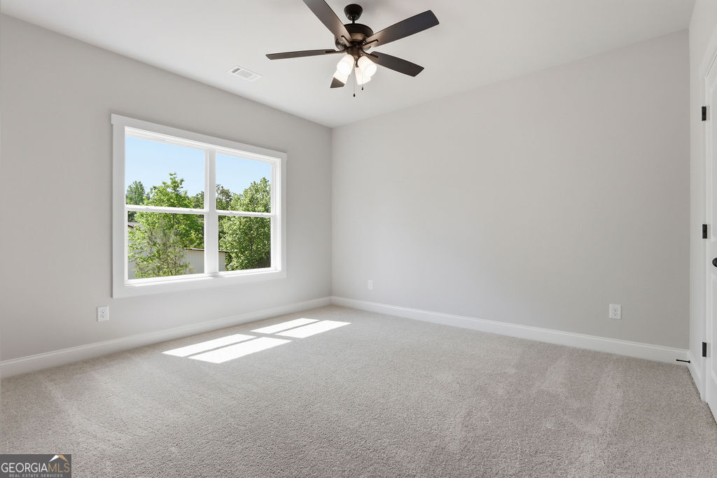 720 Youth Jersey Road Loganville, GA 30052 - Photo 26 of 31 an empty room with windows and fan