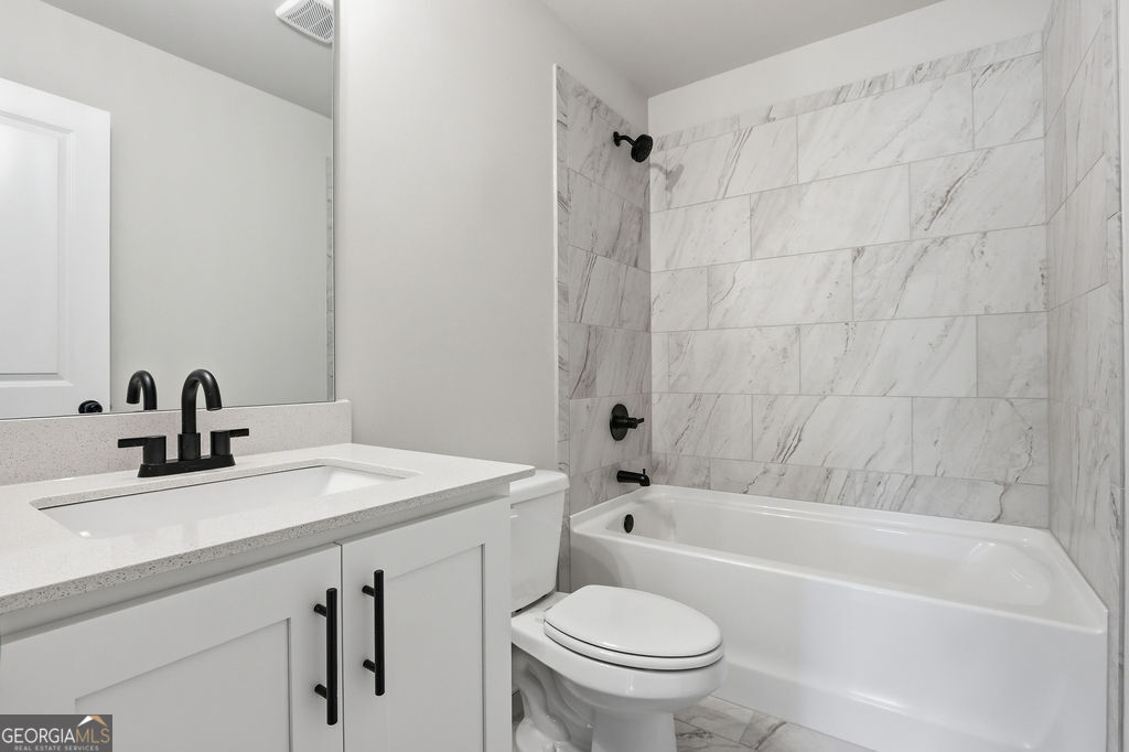 720 Youth Jersey Road Loganville, GA 30052 - Photo 28 of 31 a bathroom with a sink a toilet and bathtub