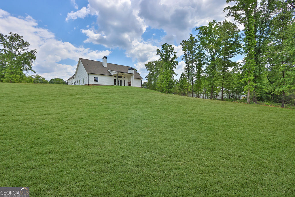 720 Youth Jersey Road Loganville, GA 30052 - Photo 31 of 31 a front view of a house with a garden