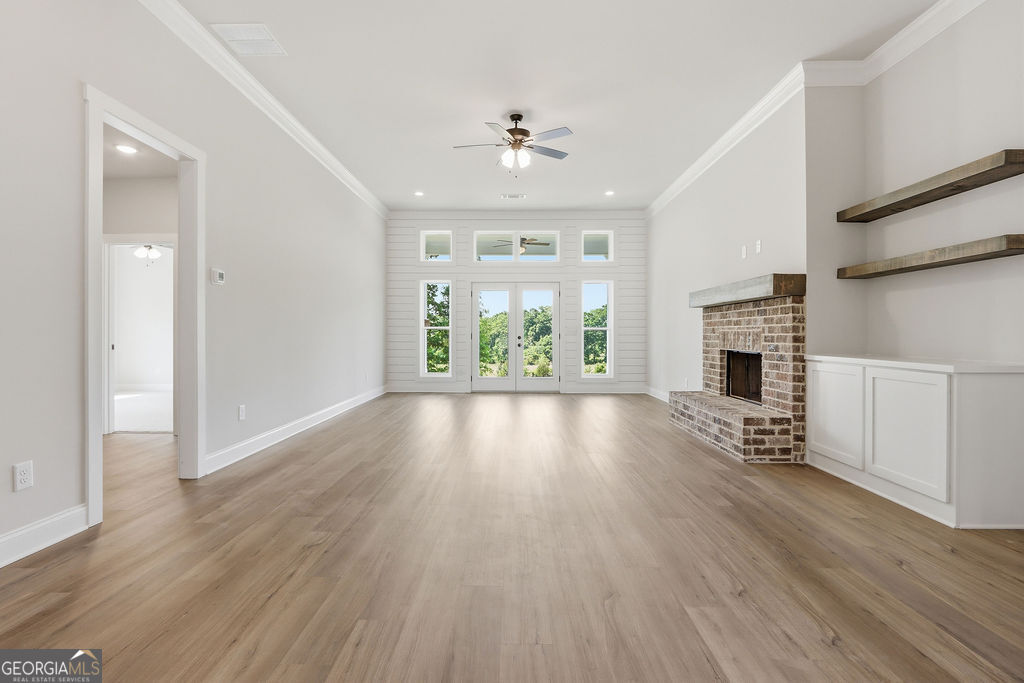720 Youth Jersey Road Loganville, GA 30052 - Photo 6 of 31 wooden floor in an empty room with a window