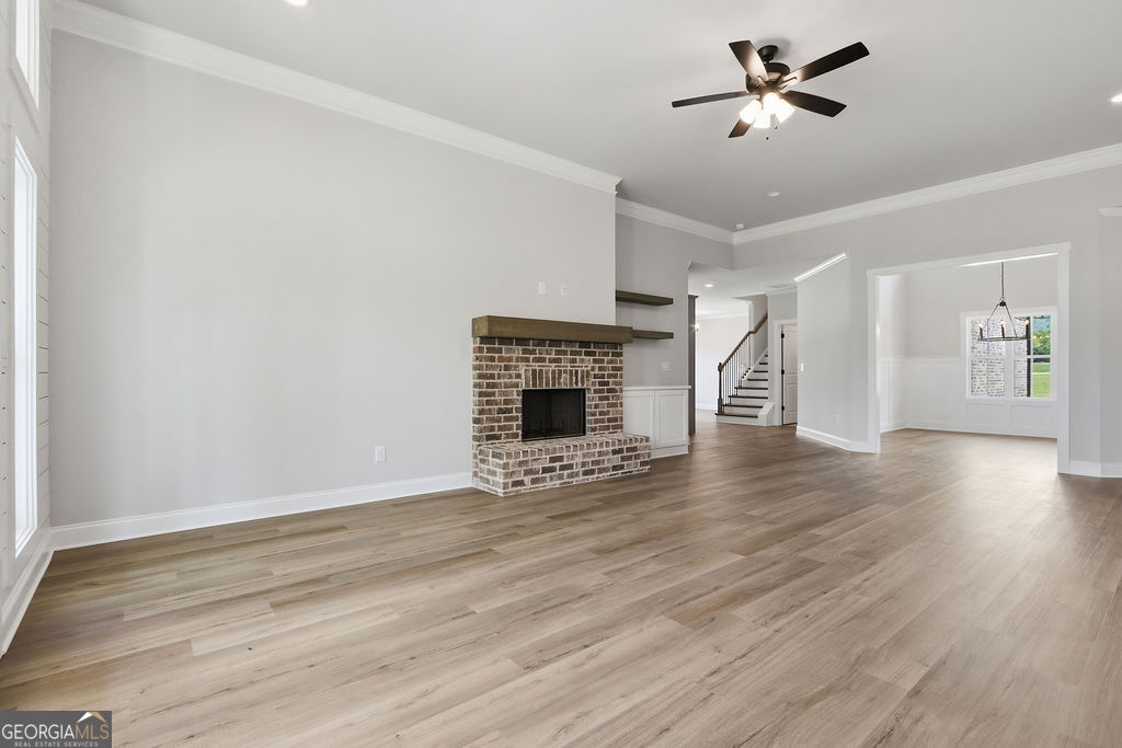 720 Youth Jersey Road Loganville, GA 30052 - Photo 7 of 31 a view of an empty room with wooden floor fireplace and a window