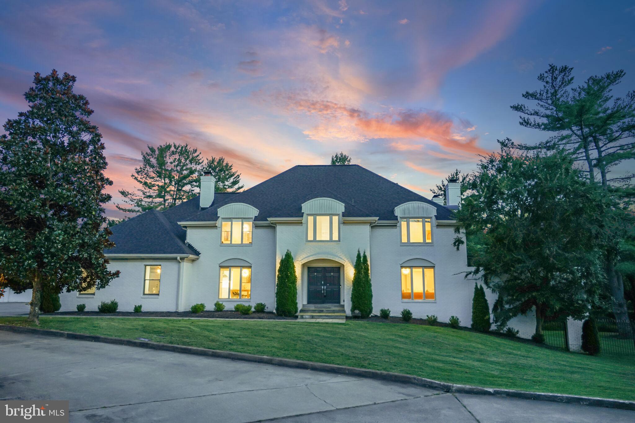 a front view of a house with a yard and a garage