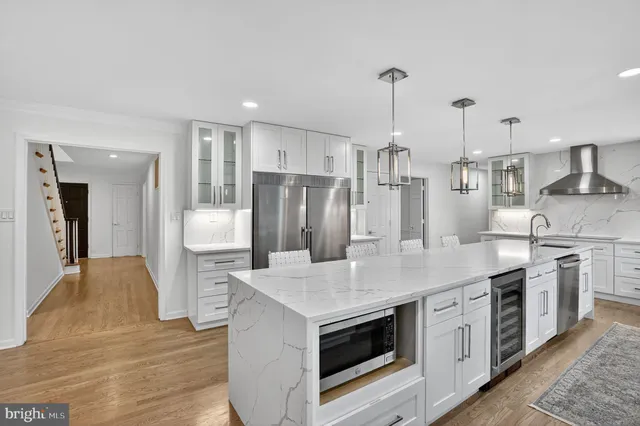 a spacious bedroom with a large bed and a wooden floor