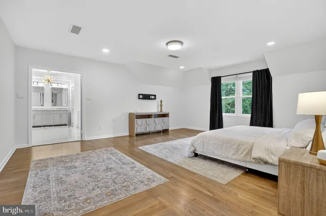a living room with furniture or chandelier and a wooden floor