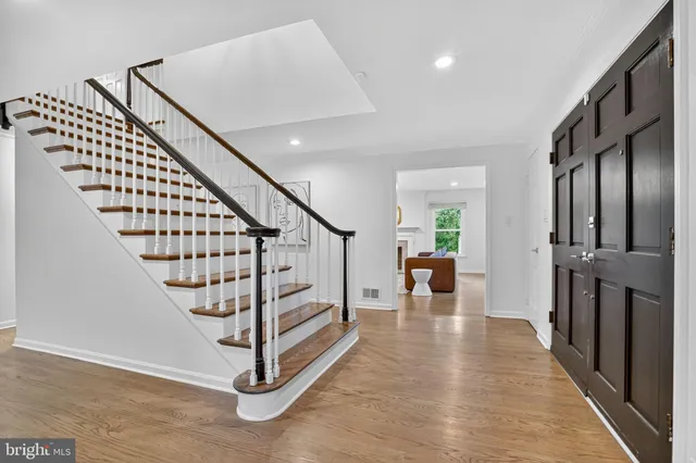 a view of entryway and hall with wooden floor