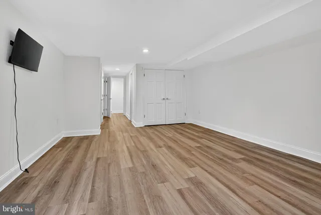 a view of a white house with a big yard and large trees