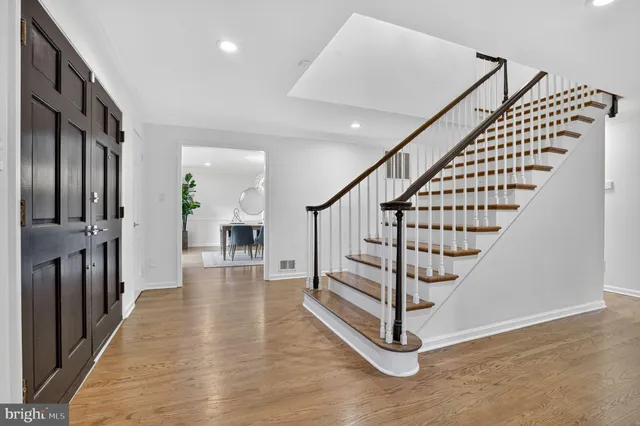 a view of a dining room with furniture a chandelier and wooden floor