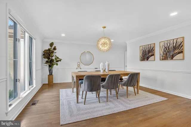 a view of a dining room with furniture wooden floor and a chandelier