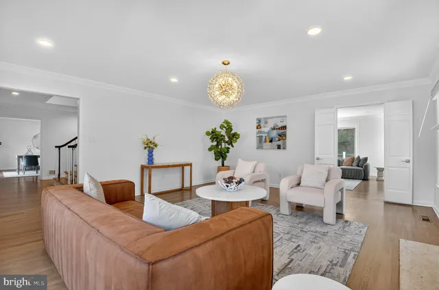a living room with furniture a fireplace and a potted plant