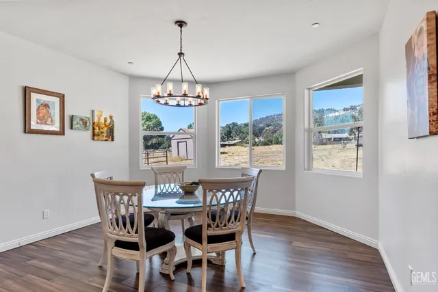 a view of a dining room with furniture wooden floor and chandelier