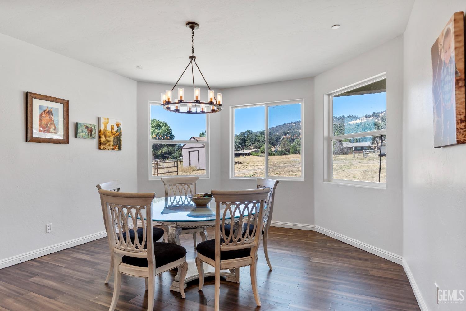 Undisclosed Address Tehachapi, CA 93561 - Photo 13 of 41 a view of a dining room with furniture wooden floor and chandelier