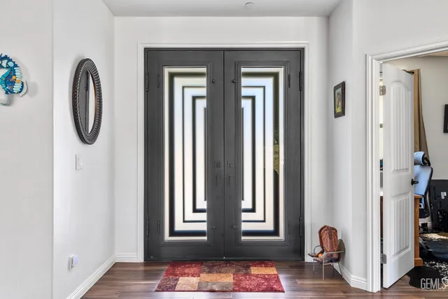 a front view of a house with entryway and wooden floor