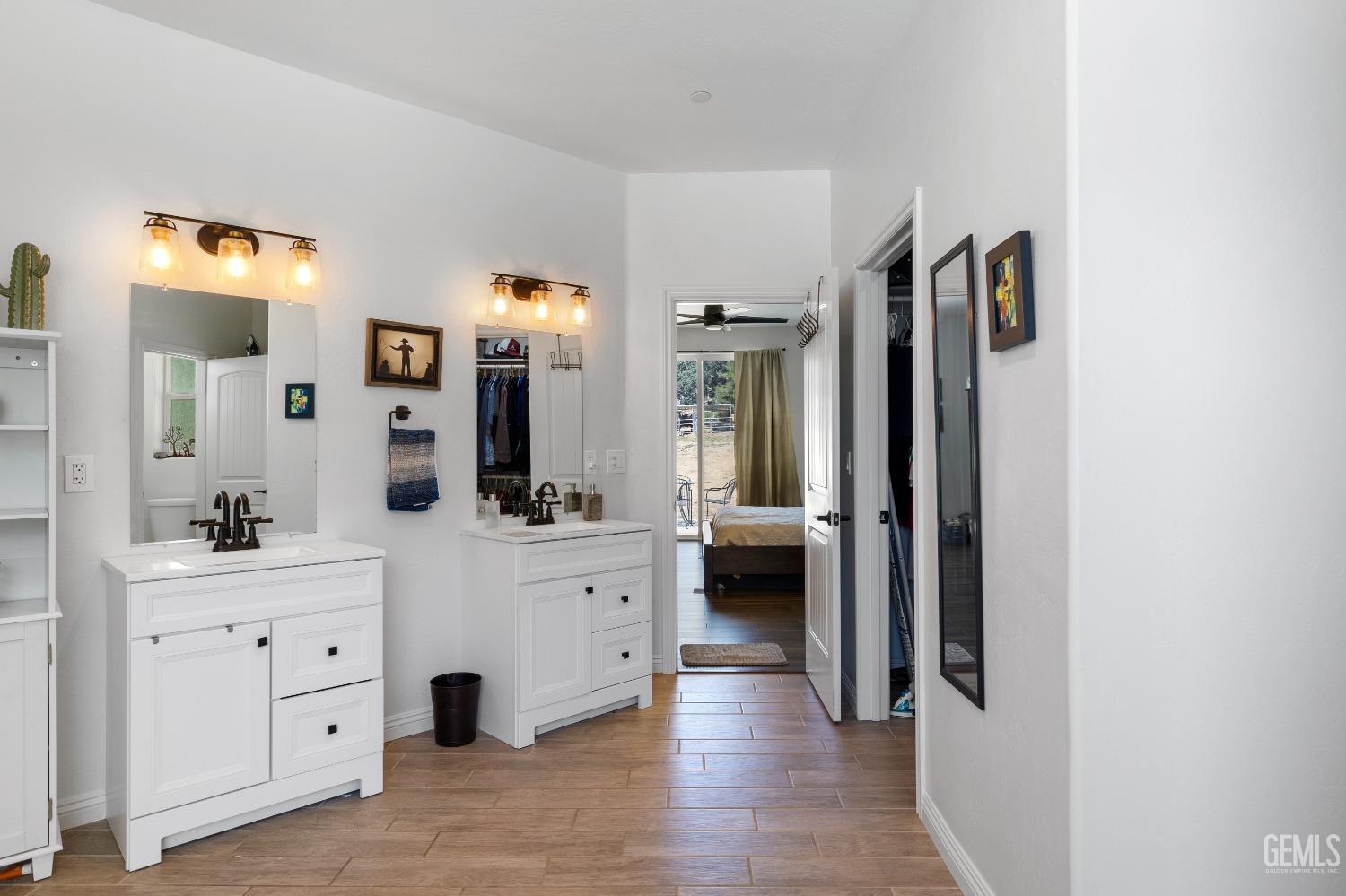 Undisclosed Address Tehachapi, CA 93561 - Photo 30 of 41 a hall with a sink and a large mirror