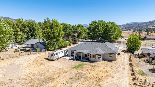 a view of a house with yard and sitting area