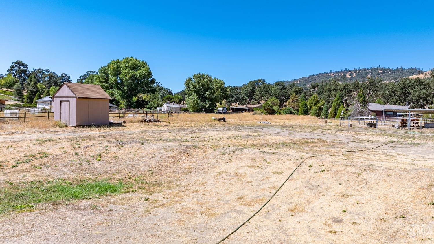 Undisclosed Address Tehachapi, CA 93561 - Photo 36 of 41 a backyard of a house with table and chairs