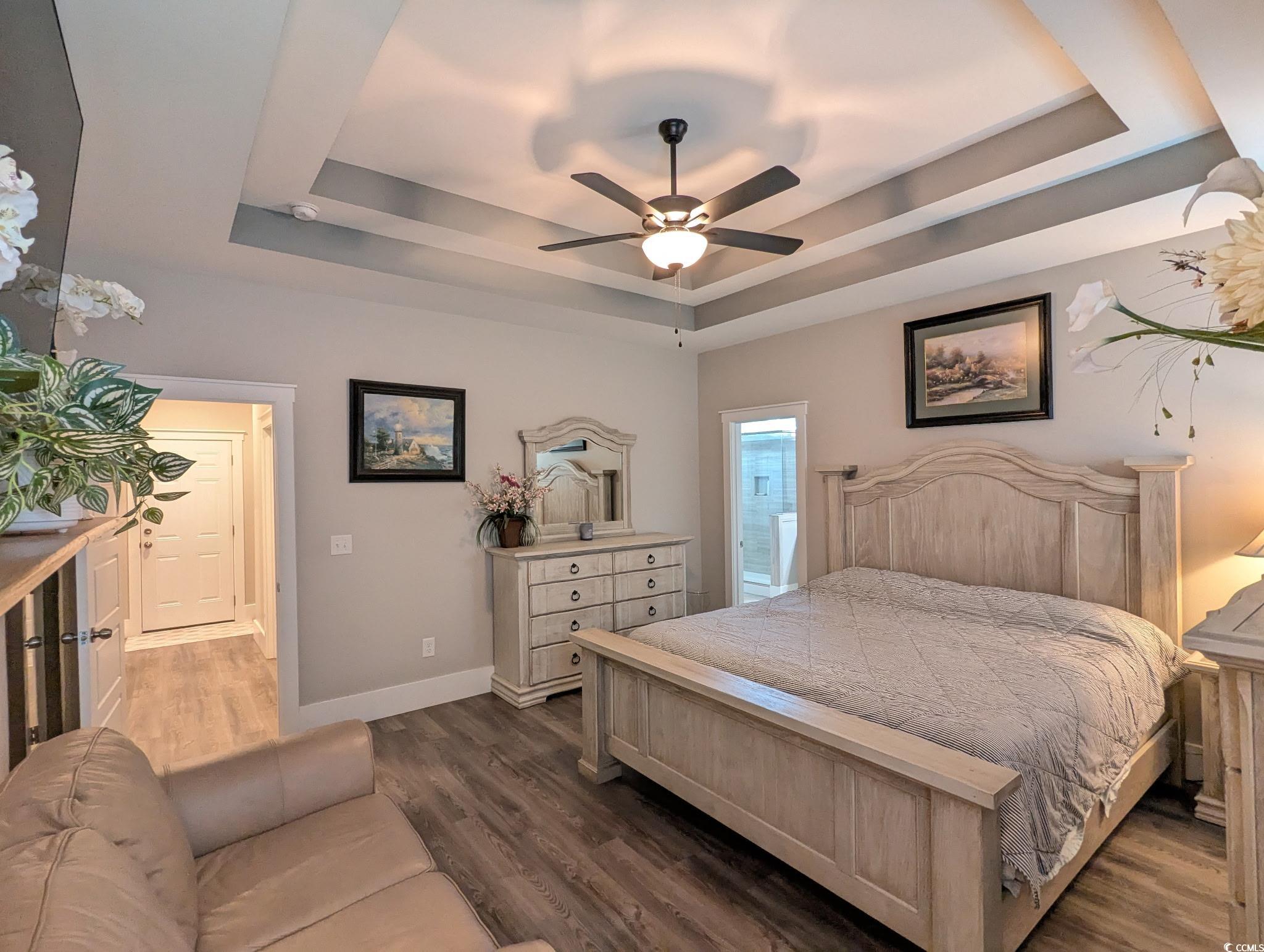 646 Pacific Commons Drive Surfside Beach, SC 29575 - Photo 14 of 40 Bedroom featuring dark wood-type flooring, a raised ceiling, and ceiling fan