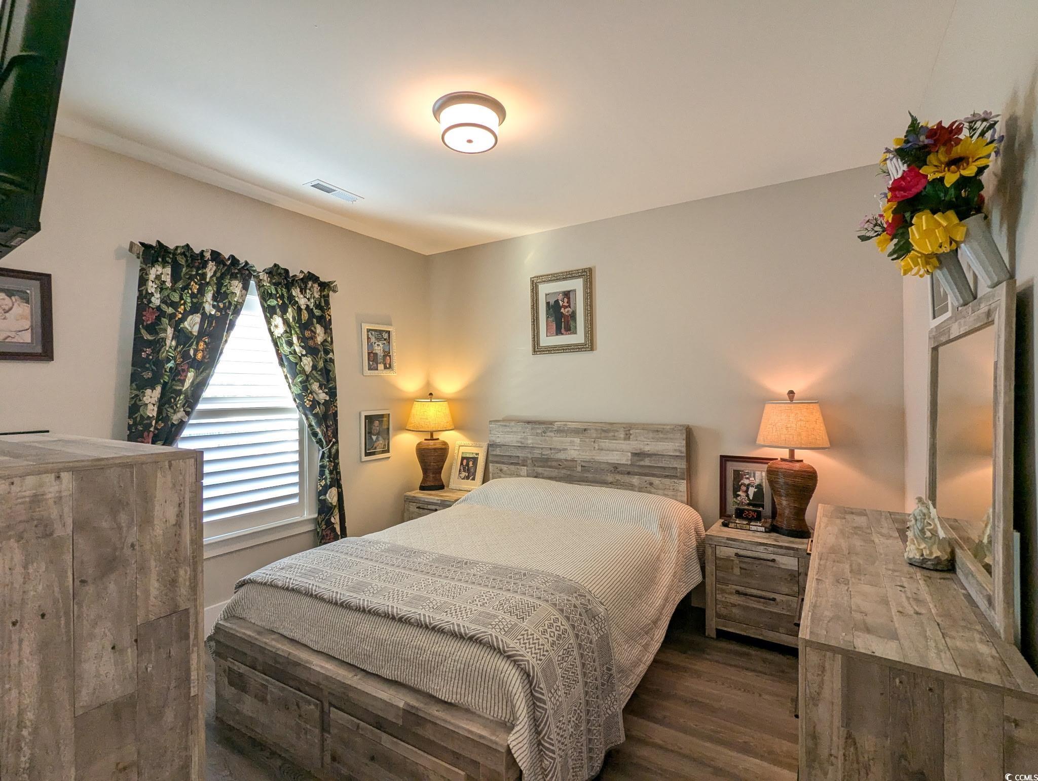 646 Pacific Commons Drive Surfside Beach, SC 29575 - Photo 18 of 40 Bedroom featuring dark wood-style floors