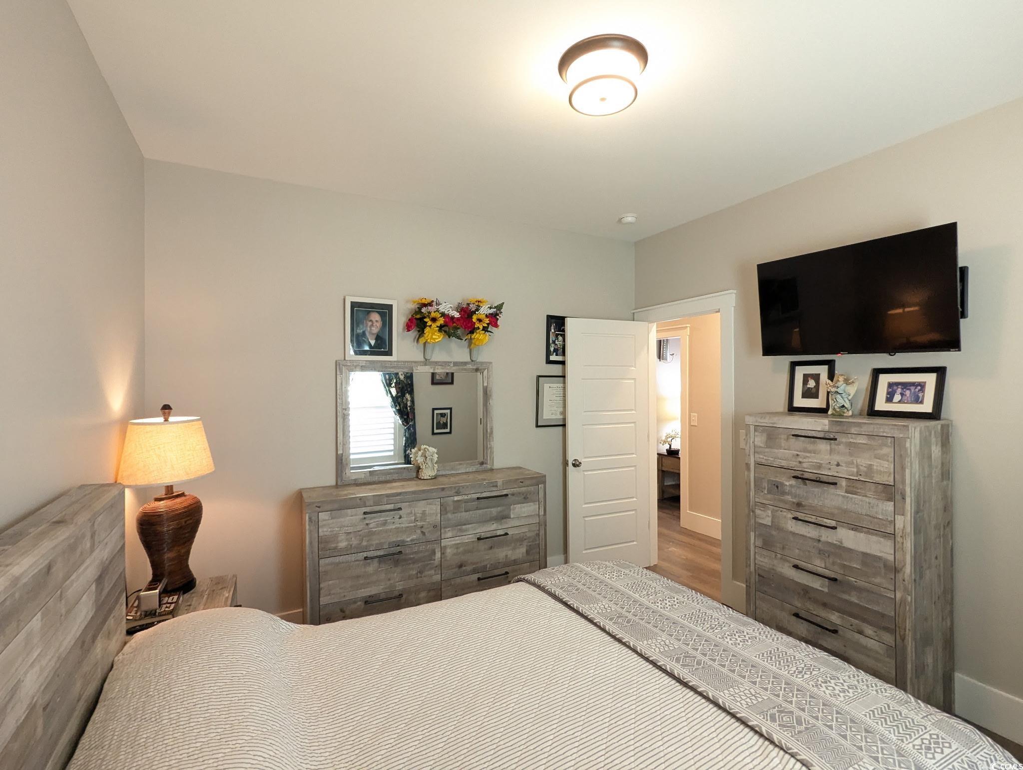 646 Pacific Commons Drive Surfside Beach, SC 29575 - Photo 19 of 40 Bedroom featuring baseboards and wood finished floors