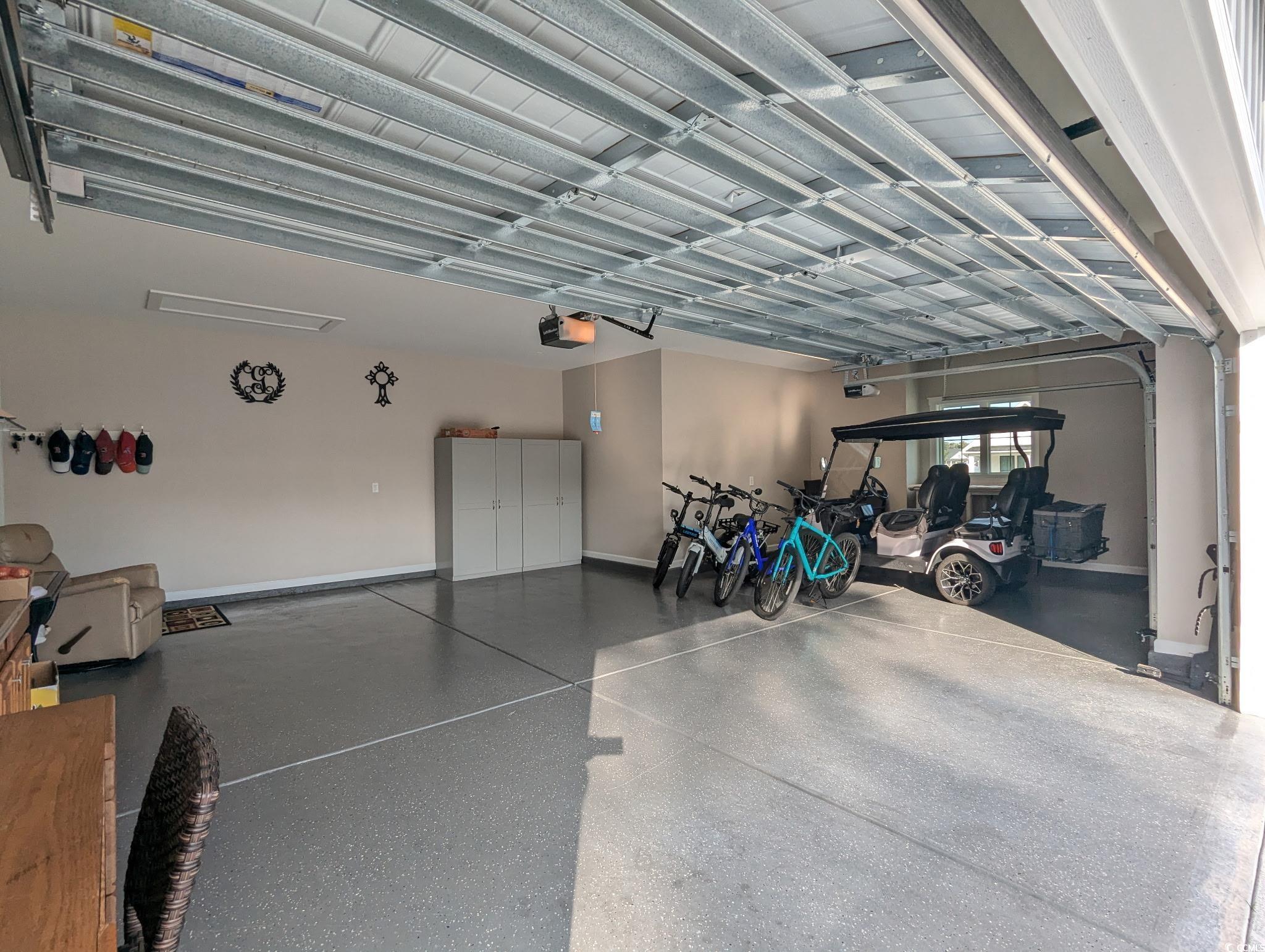 646 Pacific Commons Drive Surfside Beach, SC 29575 - Photo 29 of 40 Garage with baseboards and a garage door opener