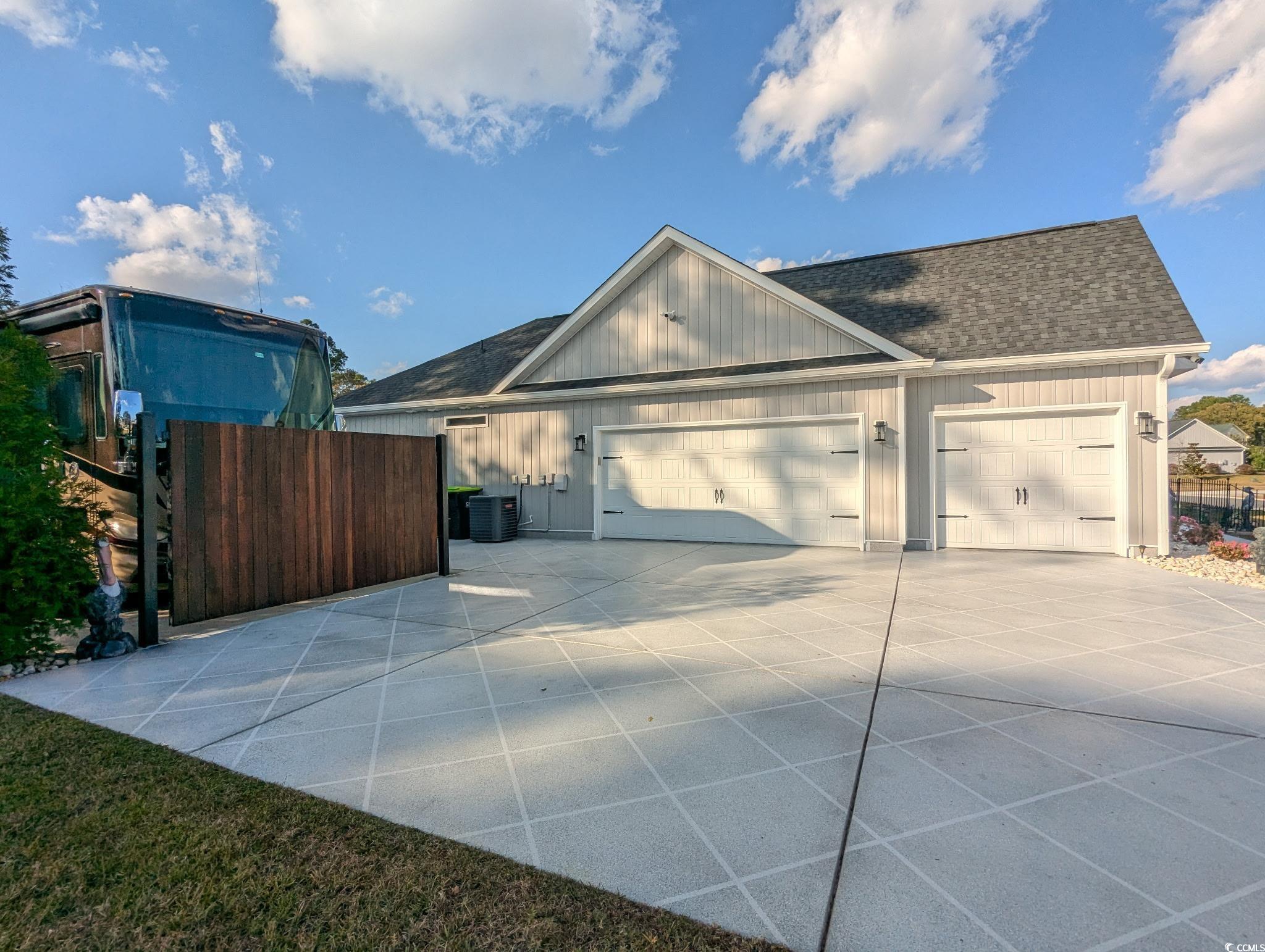 646 Pacific Commons Drive Surfside Beach, SC 29575 - Photo 30 of 40 3-Car Garage with roof with shingles, a garage, and driveway