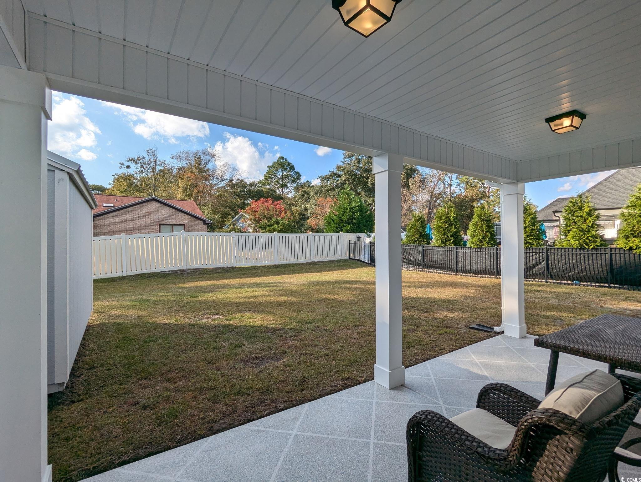 646 Pacific Commons Drive Surfside Beach, SC 29575 - Photo 32 of 40 Fenced backyard with a patio area