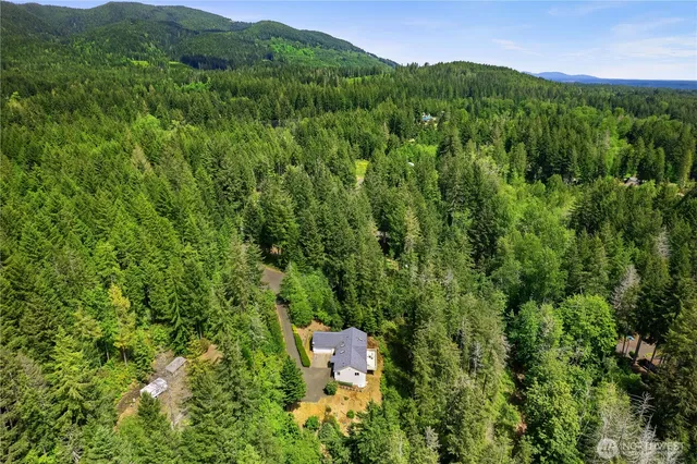 an aerial view of a house with a yard
