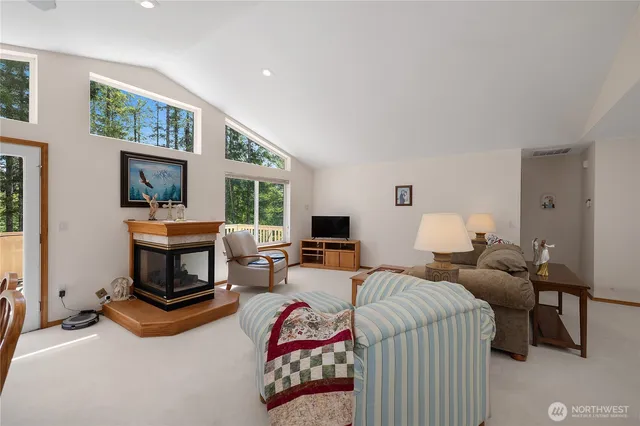 a living room with furniture a window and a flat screen tv