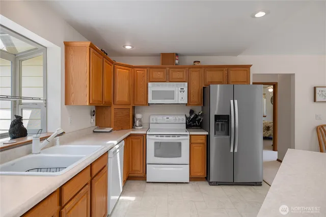 a kitchen with a sink stove and refrigerator