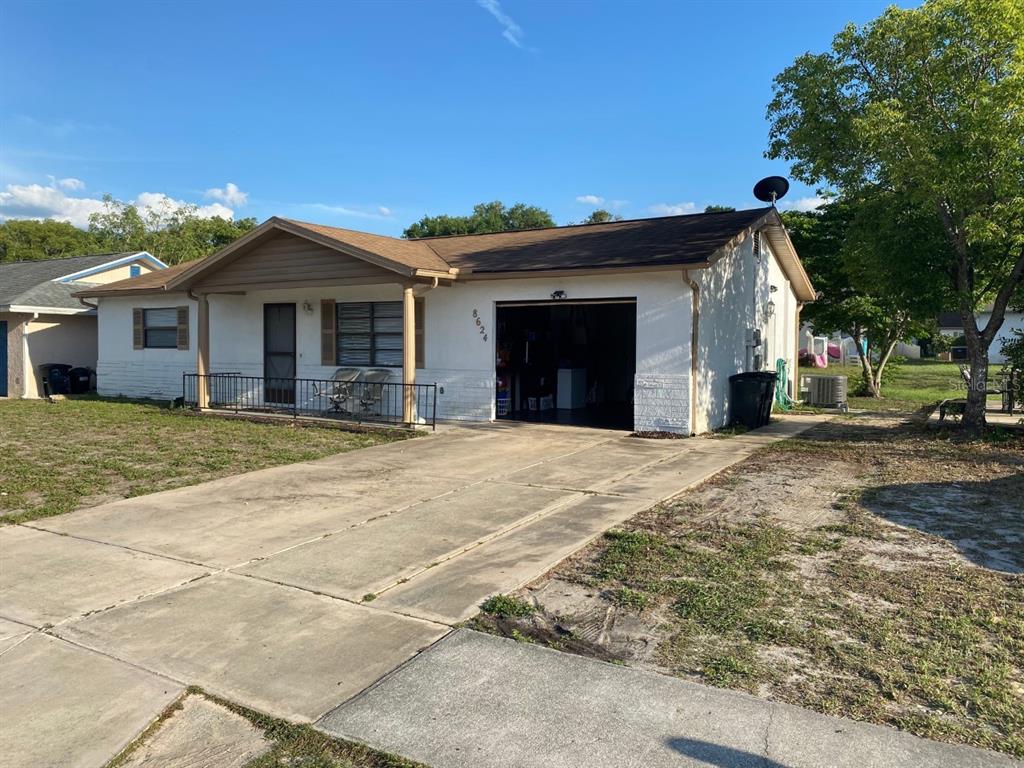 8624 Zane Lane Port Richey, FL 34668 - Photo 1 of 1 a view of a house with a yard