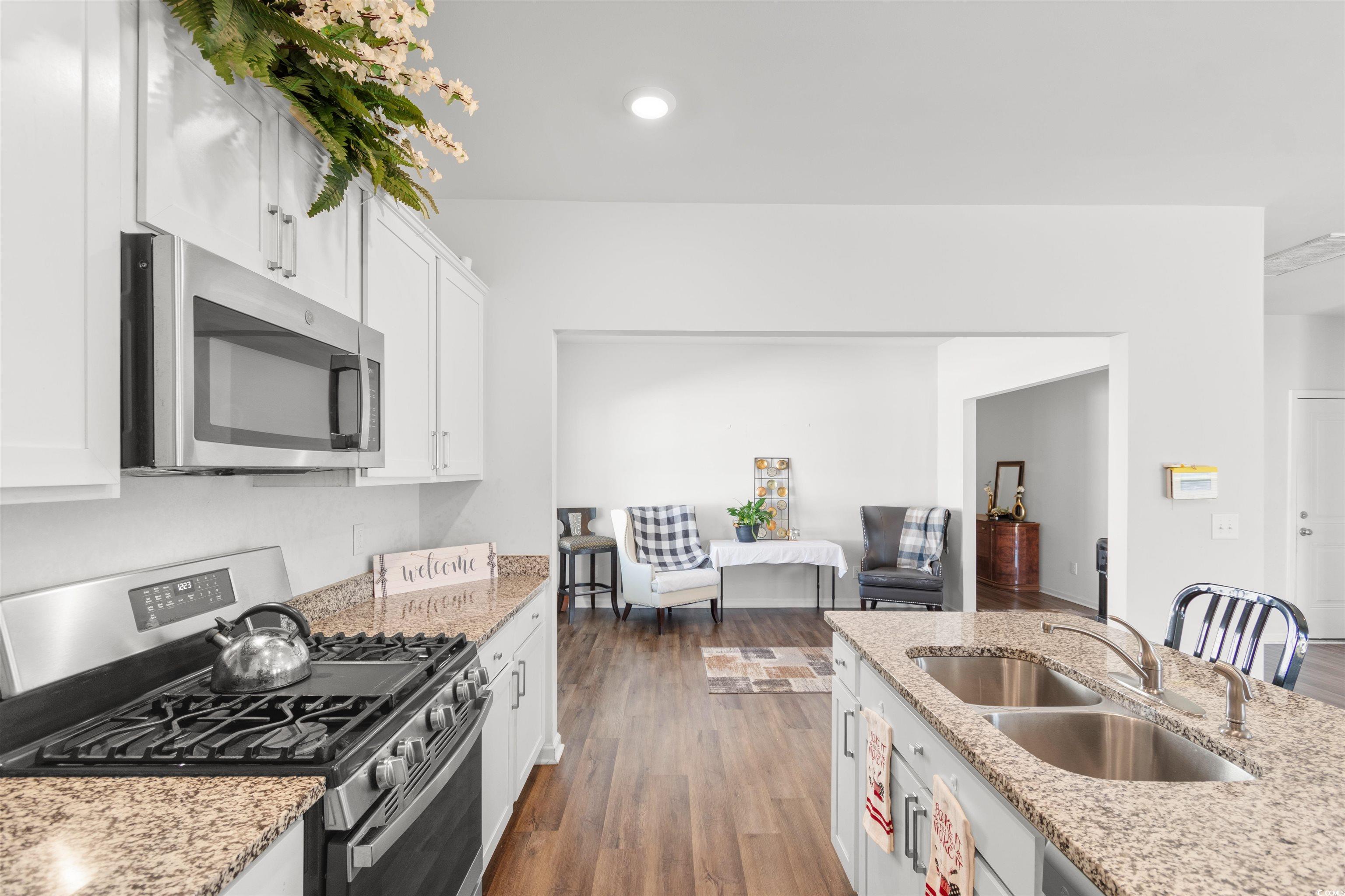 430 Stevia Court Conway, SC 29526 - Photo 12 of 40 Kitchen with stainless steel appliances, dark wood-type flooring, white cabinets, light stone counters, and recessed lighting