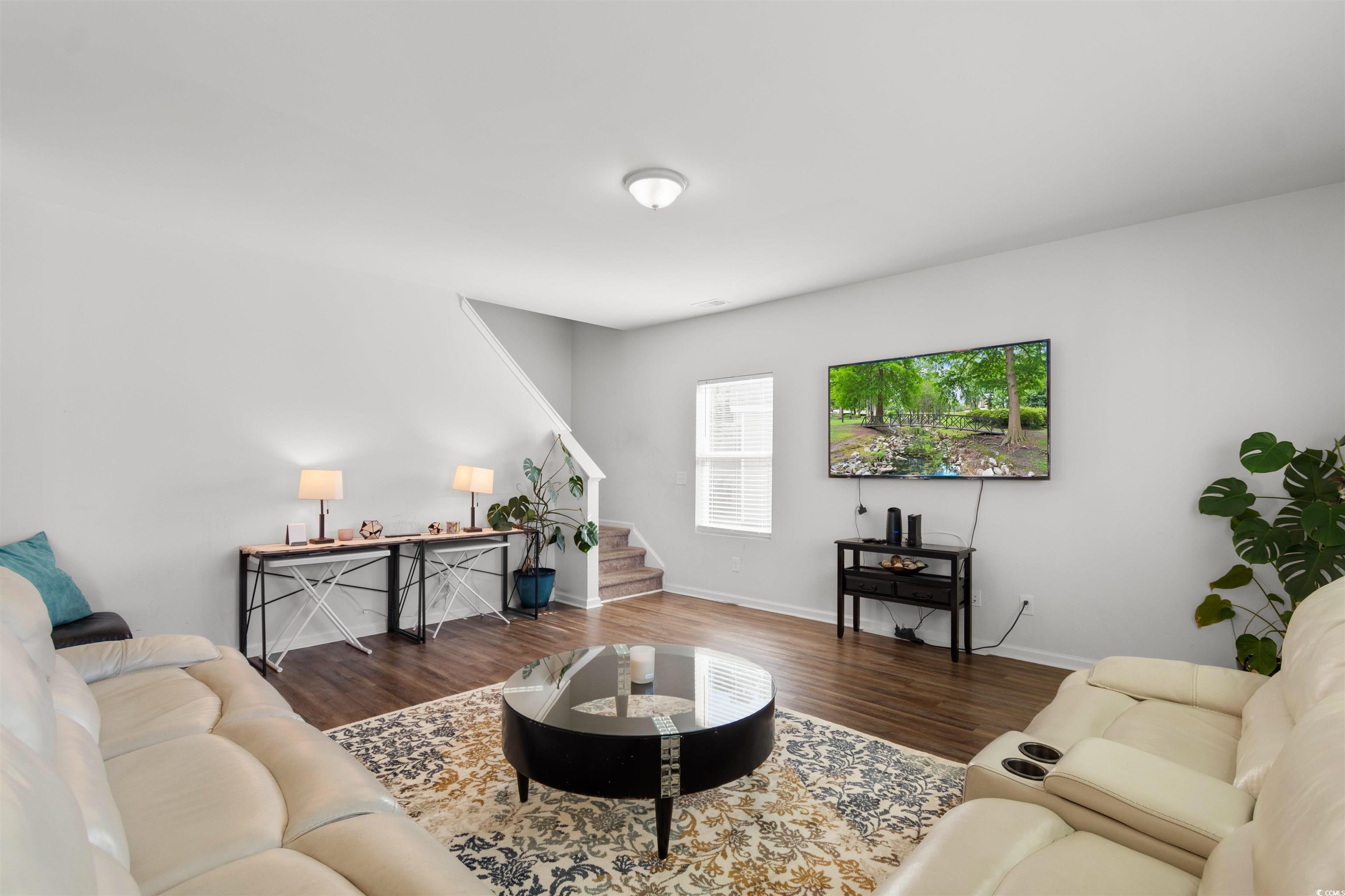 430 Stevia Court Conway, SC 29526 - Photo 15 of 40 Living area featuring stairs and dark wood-type flooring