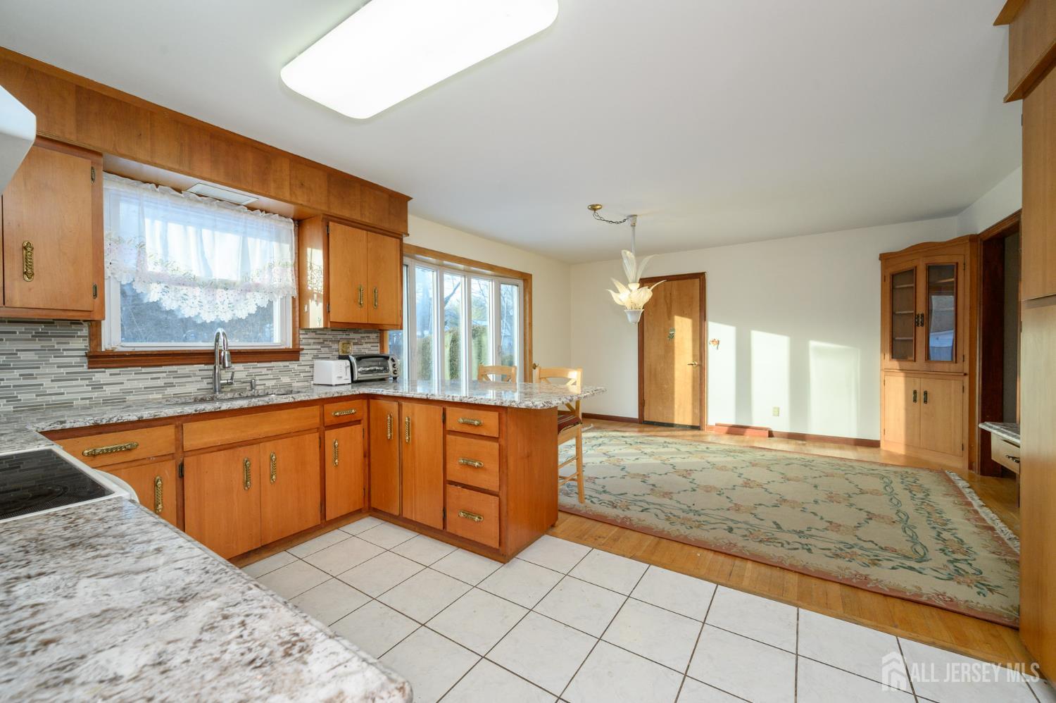 1821 Englishtown Road Old Bridge, NJ 08857 - Photo 12 of 46 a large kitchen with stainless steel appliances granite countertop a sink and cabinets