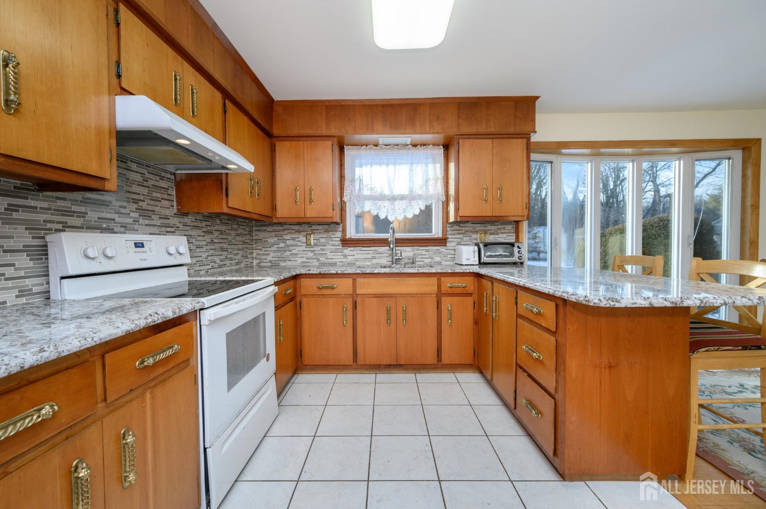1821 Englishtown Road Old Bridge, NJ 08857 - Photo 13 of 46 a kitchen with stainless steel appliances granite countertop a sink and cabinets