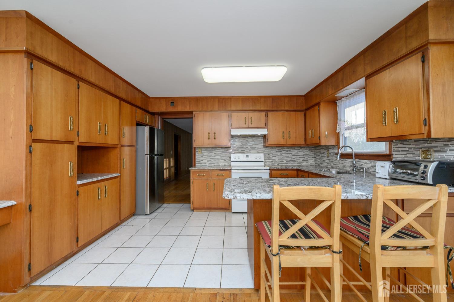 1821 Englishtown Road Old Bridge, NJ 08857 - Photo 16 of 46 a kitchen with a refrigerator a sink and cabinets