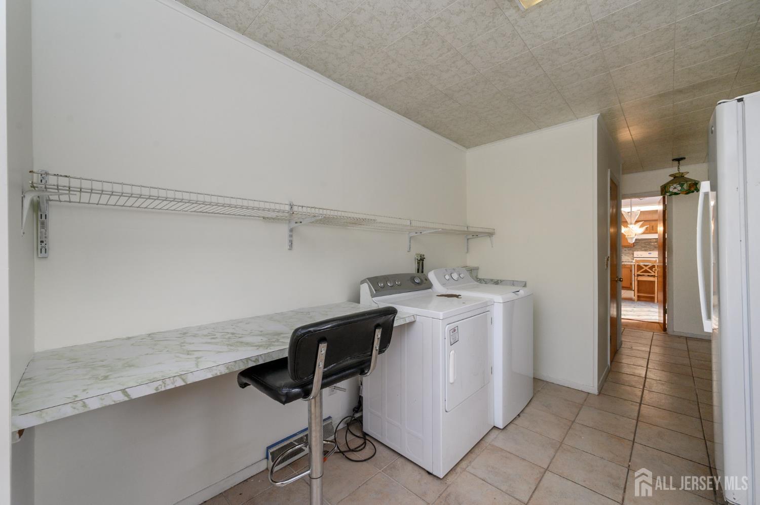 1821 Englishtown Road Old Bridge, NJ 08857 - Photo 19 of 46 a utility room with cabinets washer and dryer