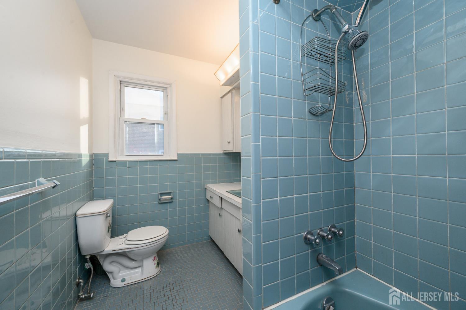1821 Englishtown Road Old Bridge, NJ 08857 - Photo 20 of 46 a bathroom with a toilet a sink and mirror
