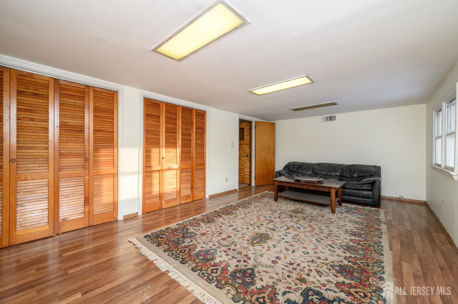 1821 Englishtown Road Old Bridge, NJ 08857 - Photo 30 of 46 a view of empty room with wooden floor and furniture