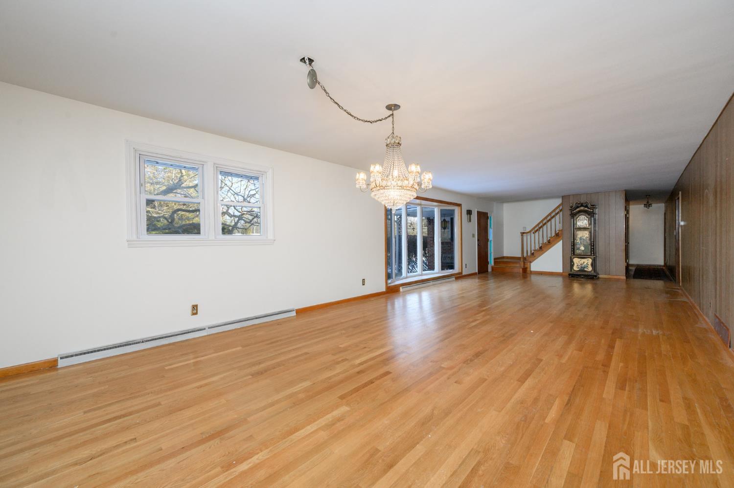 1821 Englishtown Road Old Bridge, NJ 08857 - Photo 5 of 46 a view of a room with wooden floor chandelier and entryway