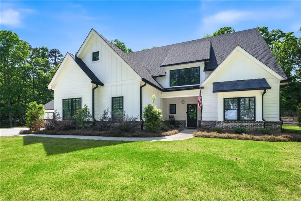 a front view of a house with a yard and outdoor seating
